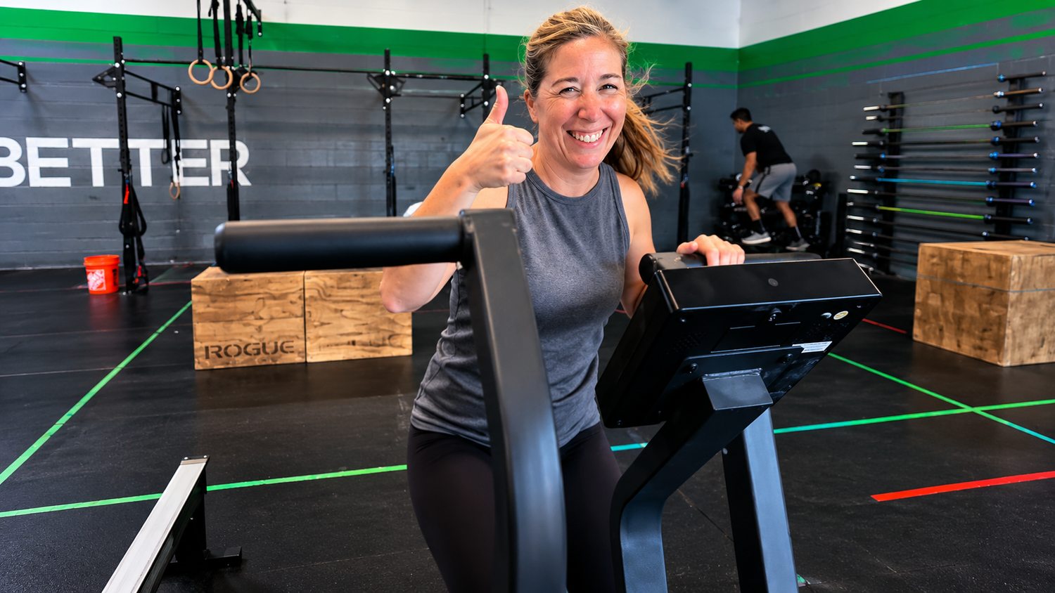 A smiling CrossFit Saol member on the assault bike