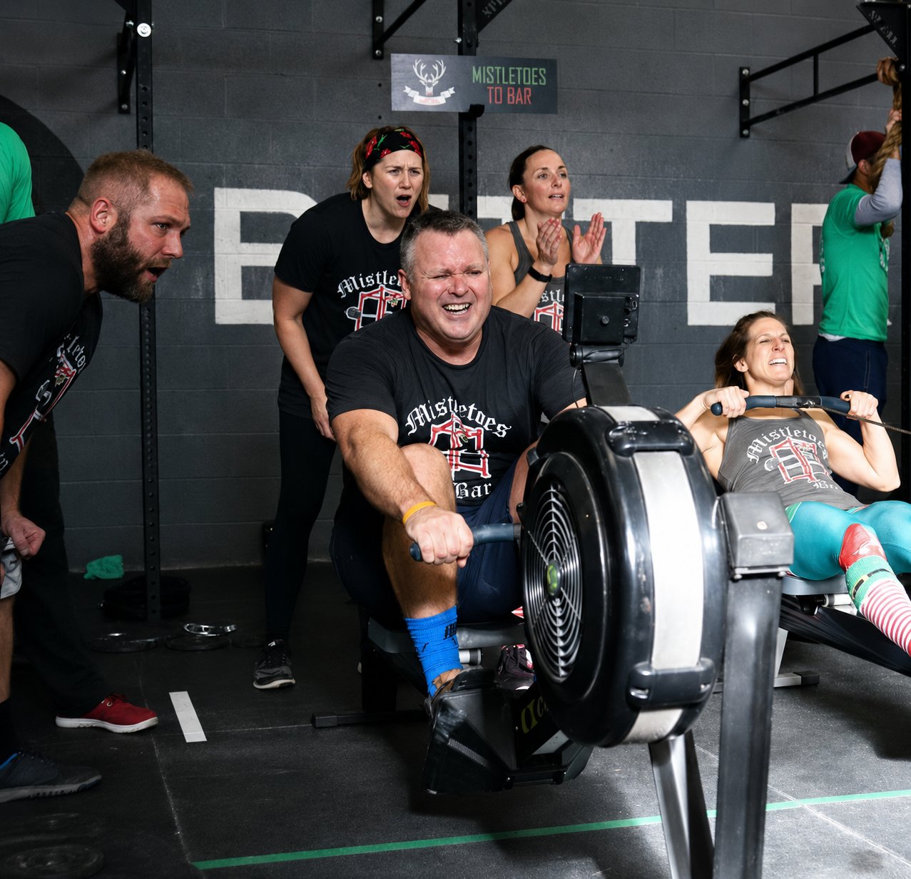 CrossFit Saol members cheering a teammate on during a rowing workout